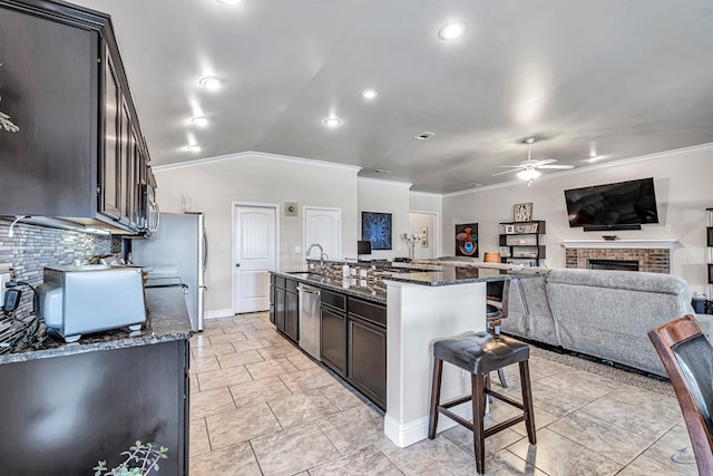 811 E 97th Ct, Odessa, TX 79765 - kitchen featuring appliances with stainless steel finishes, a ceiling fan, a sink, ornamental molding, and tasteful backsplash
