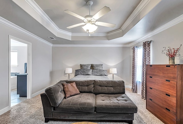 811 E 97th Ct, Odessa, TX 79765 - carpeted bedroom featuring a tray ceiling, ornamental molding, baseboards, ensuite bath, and ceiling fan