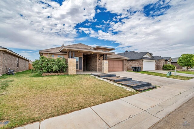 811 E 97th Ct, Odessa, TX 79765 - view of front facade featuring an attached garage, driveway, a front yard, brick siding, and a shingled roof