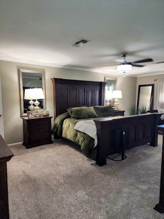 bedroom featuring crown molding, carpet flooring, ceiling fan, and visible vents