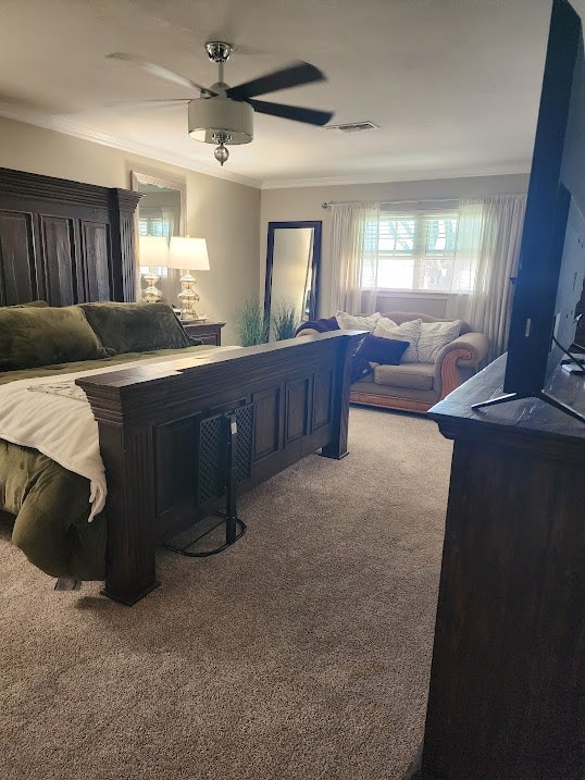 bedroom featuring crown molding, carpet, a ceiling fan, and visible vents