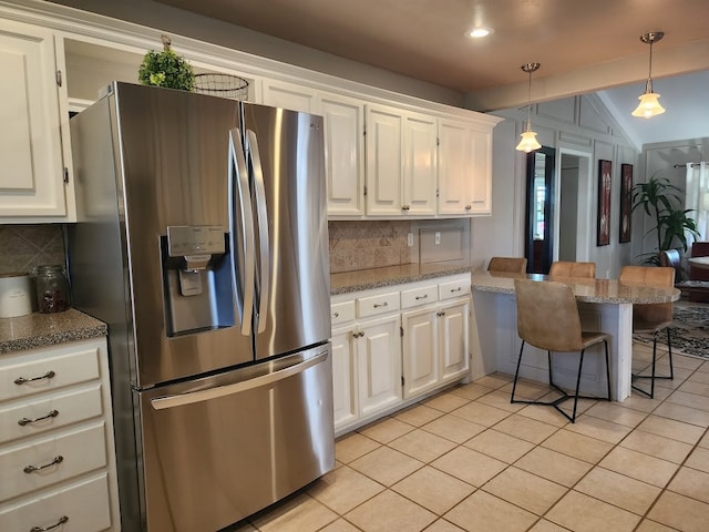 kitchen with light tile patterned floors, backsplash, white cabinetry, and stainless steel refrigerator with ice dispenser
