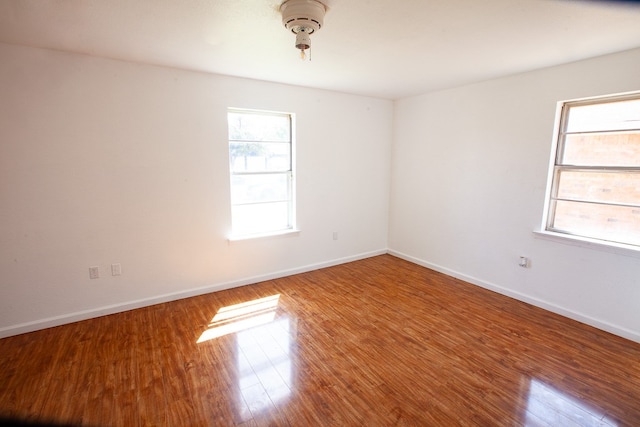 8731 Dublin Ave, Odessa, TX 79765 - unfurnished room with baseboards and wood finished floors