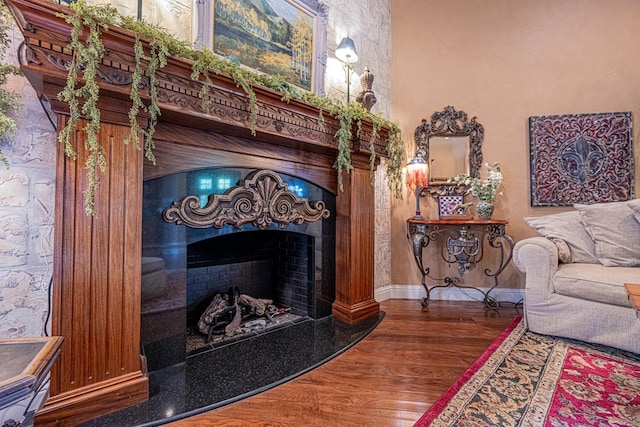 3115 Palo Verde Gln, Midland, TX 79705 - living room featuring a fireplace, wood finished floors, and baseboards
