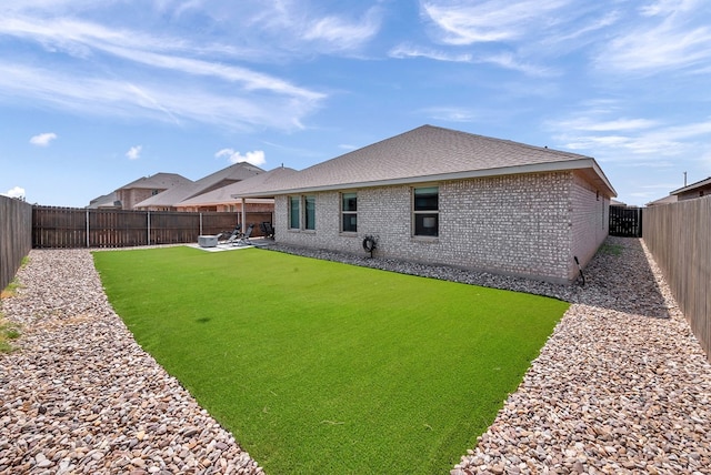 8409 E County Rd 115, Midland, TX 79706 - back of property with brick siding, a fenced backyard, a patio area, and a shingled roof