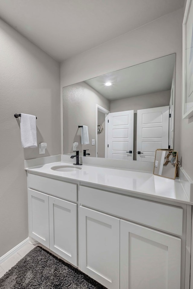 8409 E County Rd 115, Midland, TX 79706 - bathroom with vanity, recessed lighting, and baseboards