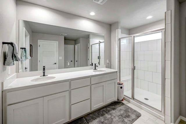 8409 E County Rd 115, Midland, TX 79706 - bathroom featuring double vanity, a shower stall, and recessed lighting
