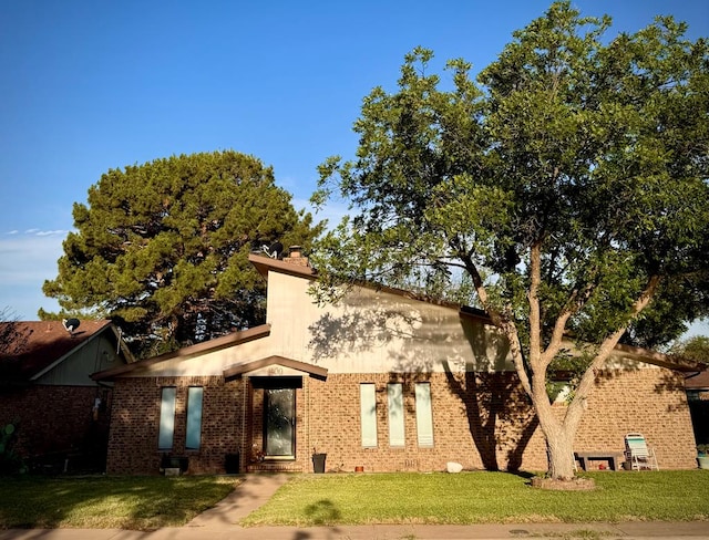 1800 Thompson, Crane, TX 79731 - view of front of home with a front yard and brick siding