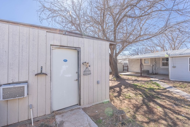 309 SW 10th St, Andrews, TX 79714 - view of exterior entry featuring a wall mounted air conditioner