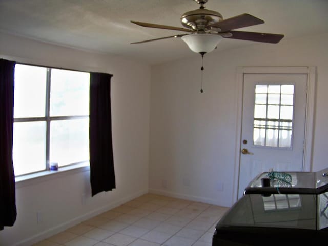 309 SW 10th St, Andrews, TX 79714 - doorway to outside featuring plenty of natural light, a ceiling fan, and light tile patterned floors