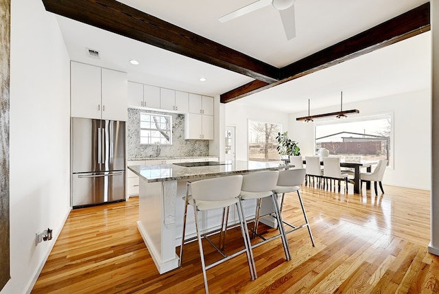1007 E Texas St, Marfa, TX 79843 - kitchen with freestanding refrigerator, light wood finished floors, a sink, a kitchen bar, and a center island