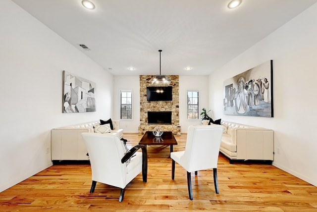 1007 E Texas St, Marfa, TX 79843 - living area featuring healthy amount of natural light, light wood-style flooring, recessed lighting, a stone fireplace, and baseboards