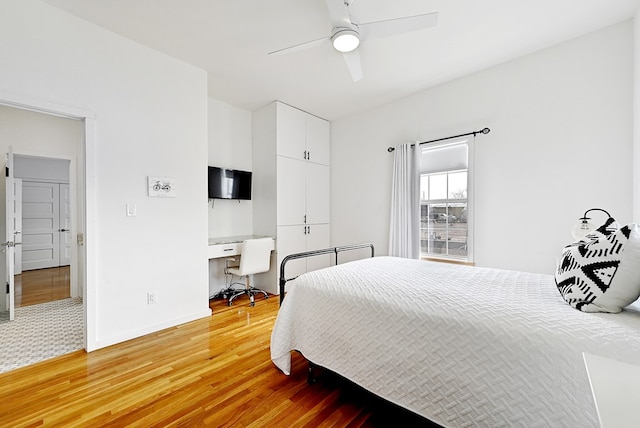 1007 E Texas St, Marfa, TX 79843 - bedroom with light wood-style flooring, an office area, baseboards, and a ceiling fan