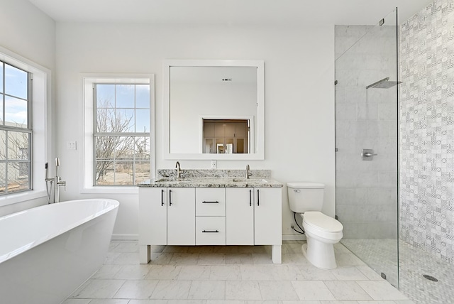 1007 E Texas St, Marfa, TX 79843 - full bathroom with a tile shower, a freestanding bath, double vanity, and baseboards
