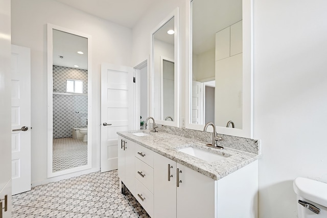 1007 E Texas St, Marfa, TX 79843 - full bath featuring toilet, tile patterned floors, double vanity, and recessed lighting