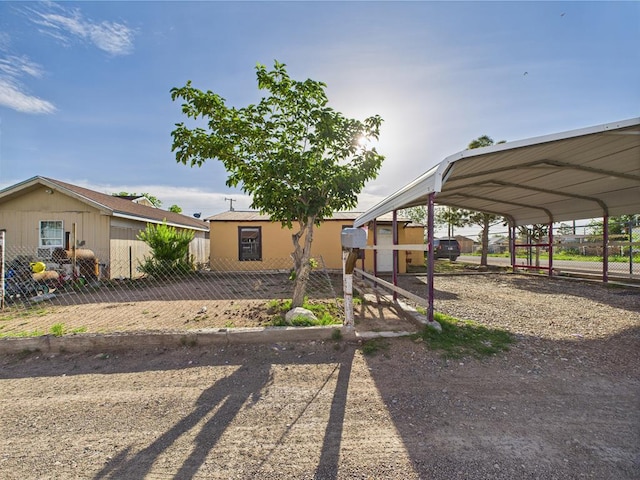 view of front of property with fence and a detached carport