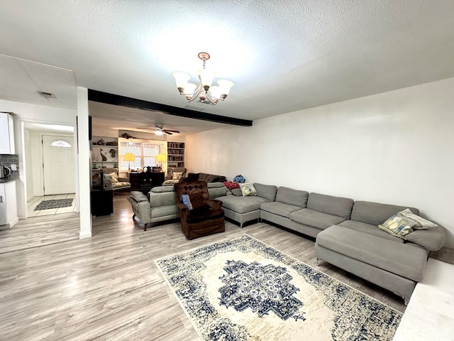 503 E Hendryx Ave, Alpine, TX 79830 - living area featuring light wood-style floors, a chandelier, a ceiling fan, and a textured ceiling