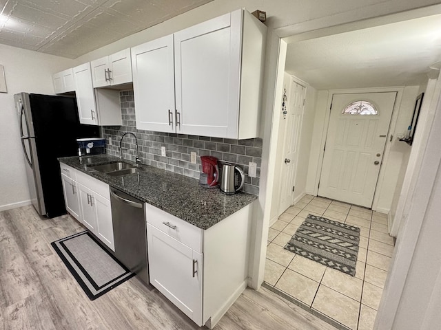 503 E Hendryx Ave, Alpine, TX 79830 - kitchen with appliances with stainless steel finishes, a sink, white cabinetry, and light wood-style flooring