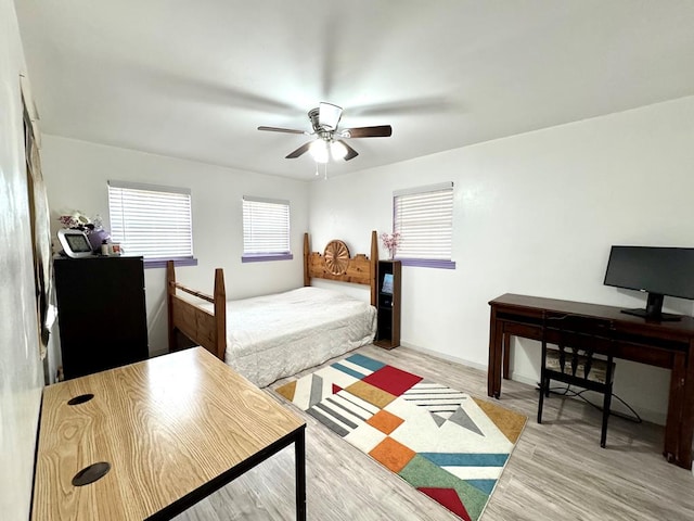 503 E Hendryx Ave, Alpine, TX 79830 - bedroom with a desk, light wood-style floors, and ceiling fan