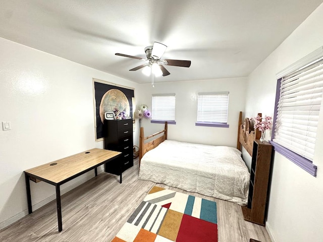 503 E Hendryx Ave, Alpine, TX 79830 - bedroom featuring light wood-style flooring, a ceiling fan, and baseboards