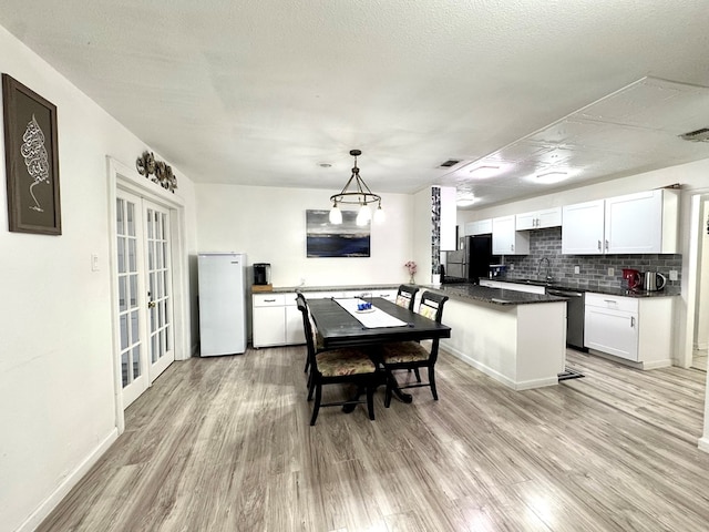 503 E Hendryx Ave, Alpine, TX 79830 - dining area featuring light wood-style floors, french doors, and baseboards