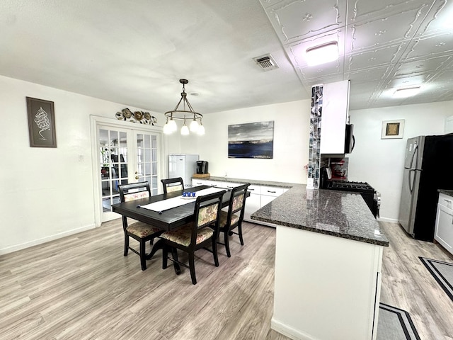 503 E Hendryx Ave, Alpine, TX 79830 - dining area with light wood-style floors, baseboards, and french doors