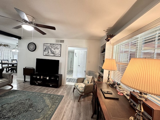 503 E Hendryx Ave, Alpine, TX 79830 - living room featuring ceiling fan, wood finished floors, and baseboards