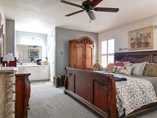 1847 Cody Pl, Odessa, TX 79762 - bedroom featuring light colored carpet, connected bathroom, and ceiling fan