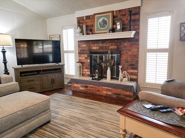 1847 Cody Pl, Odessa, TX 79762 - living room with lofted ceiling, a fireplace, wood finished floors, and a textured ceiling