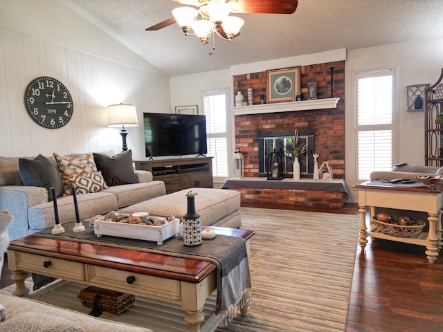 1847 Cody Pl, Odessa, TX 79762 - living area with vaulted ceiling, a ceiling fan, wood finished floors, healthy amount of natural light, and a brick fireplace
