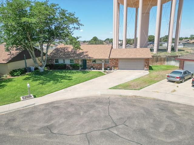 1847 Cody Pl, Odessa, TX 79762 - view of front of house featuring concrete driveway, a front lawn, an attached garage, and brick siding