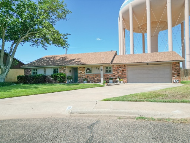 1847 Cody Pl, Odessa, TX 79762 - view of front facade with a front yard, brick siding, and concrete driveway