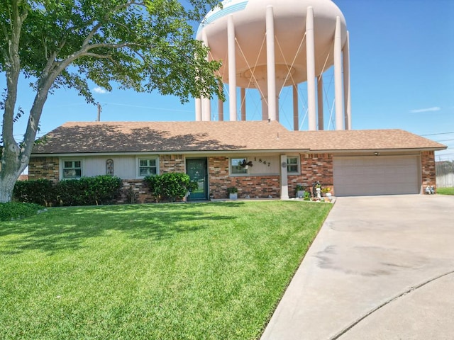 1847 Cody Pl, Odessa, TX 79762 - view of front of home with an attached garage, brick siding, a front yard, and concrete driveway