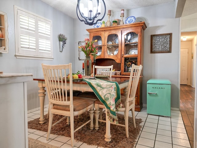 1847 Cody Pl, Odessa, TX 79762 - dining room featuring a textured ceiling, a chandelier, and light tile patterned floors
