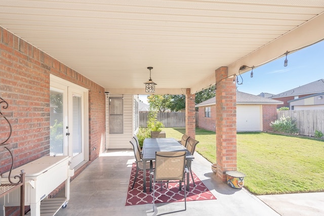 view of patio featuring an outbuilding and a garage