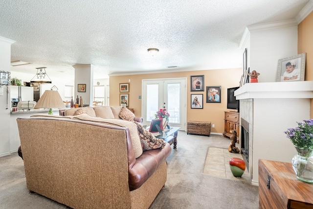 carpeted living room with french doors, a textured ceiling, and ornamental molding