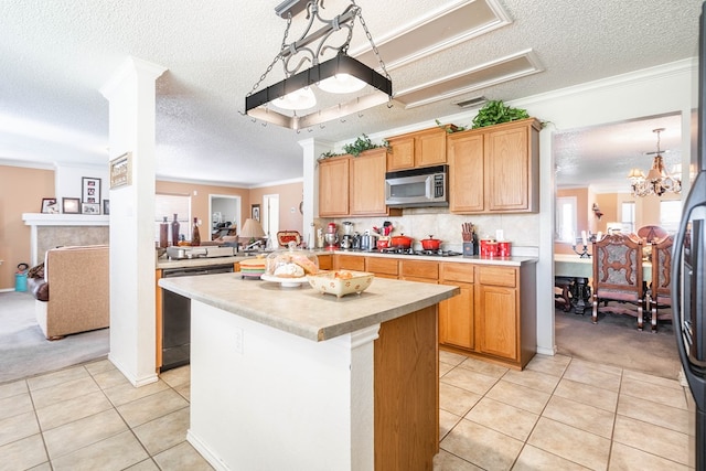 kitchen featuring kitchen peninsula, appliances with stainless steel finishes, ornamental molding, a textured ceiling, and light tile patterned floors