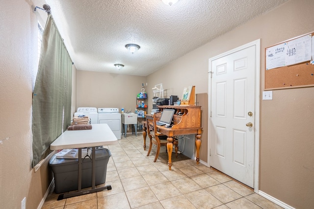 laundry room with light tile patterned floors, a textured ceiling, separate washer and dryer, and sink