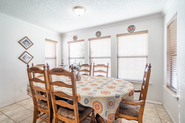 dining space with light tile patterned floors, a textured ceiling, and ornamental molding