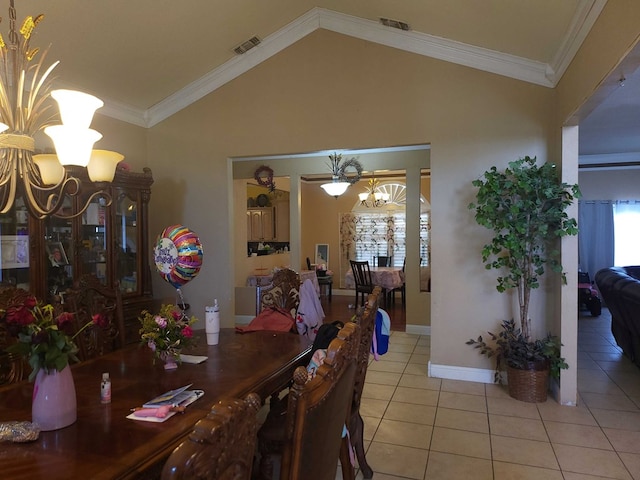 dining room with lofted ceiling, light tile patterned floors, visible vents, a chandelier, and crown molding