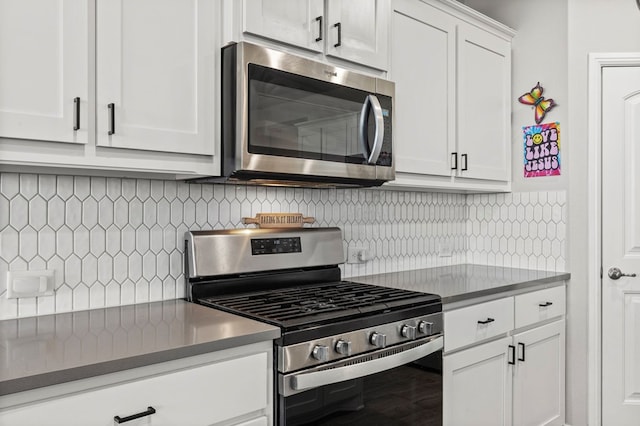 3102 Mearns Ct, Midland, TX 79705 - kitchen with stainless steel appliances, white cabinets, tasteful backsplash, and dark countertops