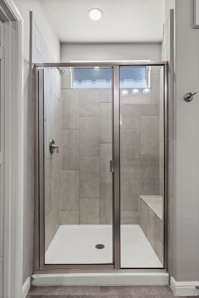 3102 Mearns Ct, Midland, TX 79705 - bathroom featuring a stall shower and baseboards