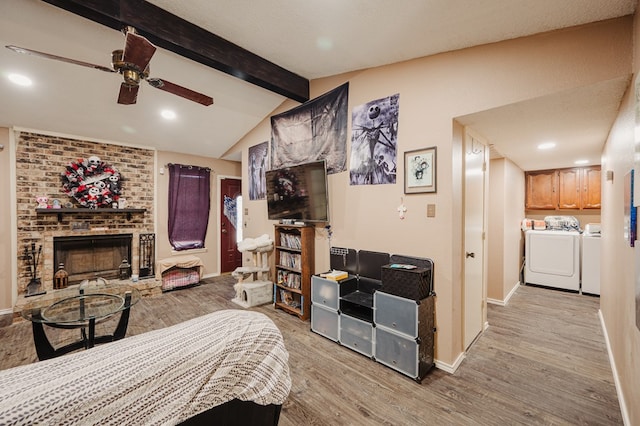 3946 Scott St, Odessa, TX 79762 - bedroom with washing machine and clothes dryer, light wood-style floors, a brick fireplace, baseboards, and recessed lighting