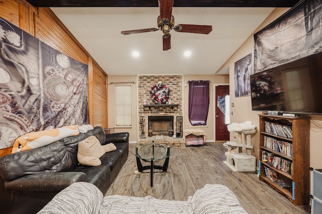 3946 Scott St, Odessa, TX 79762 - living room with wood finished floors, ceiling fan, and a fireplace