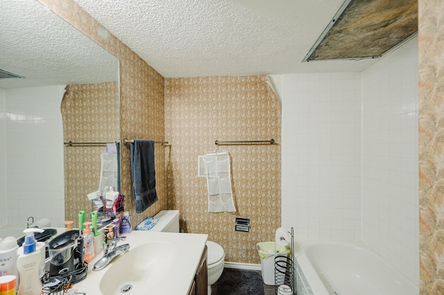 3946 Scott St, Odessa, TX 79762 - full bath with a textured ceiling, toilet, vanity, shower / tub combination, and baseboards