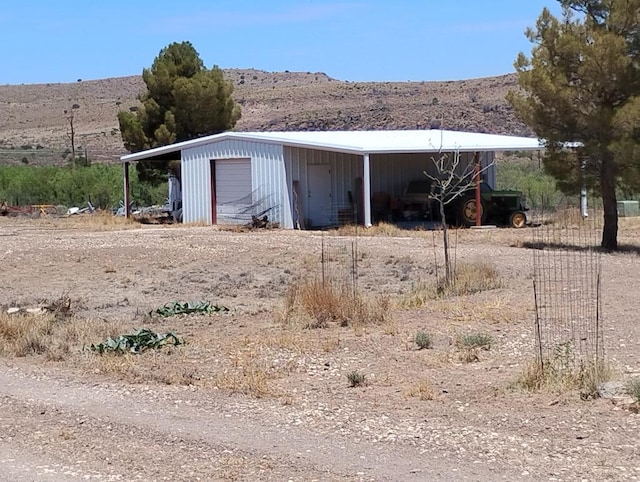735 S Front St, Fort Davis, TX 79734 - view of outdoor structure featuring a mountain view and dirt driveway