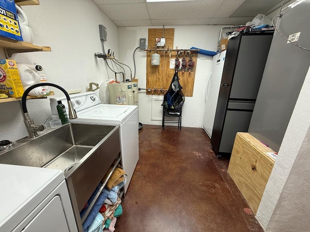 735 S Front St, Fort Davis, TX 79734 - washroom featuring separate washer and dryer, electric water heater, and a textured wall