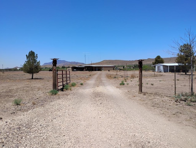 735 S Front St, Fort Davis, TX 79734 - view of dirt / gravel driveway with a mountain view, a view of countryside, and a gated entry