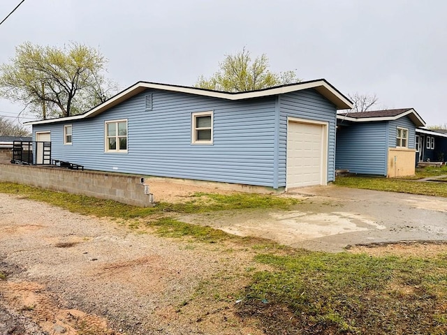 301 SW 11th St, Andrews, TX 79714 - view of home's exterior featuring a garage and driveway