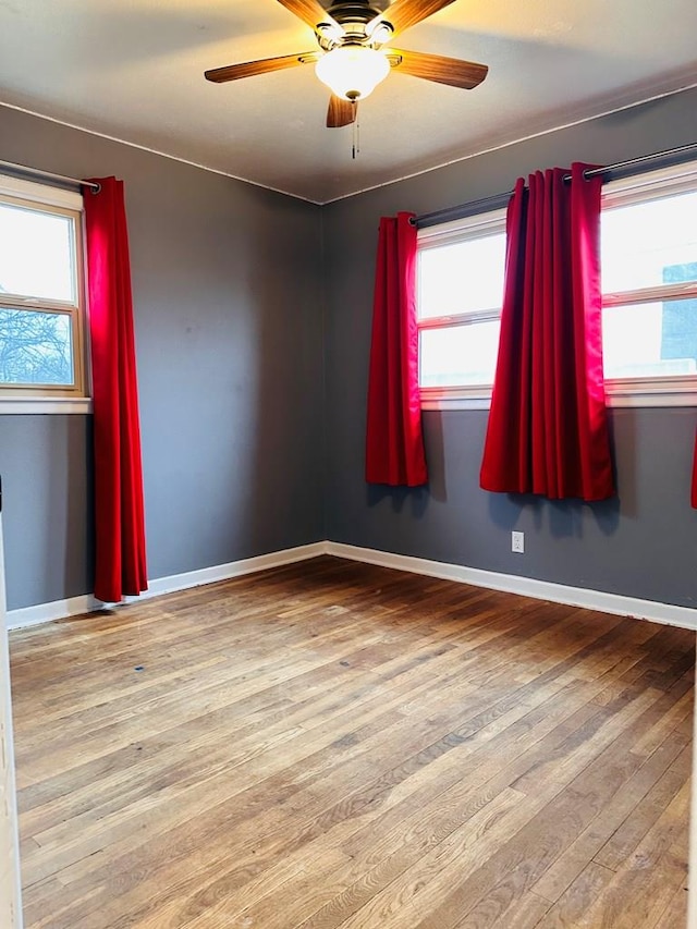 301 SW 11th St, Andrews, TX 79714 - spare room featuring hardwood / wood-style flooring, plenty of natural light, and a ceiling fan
